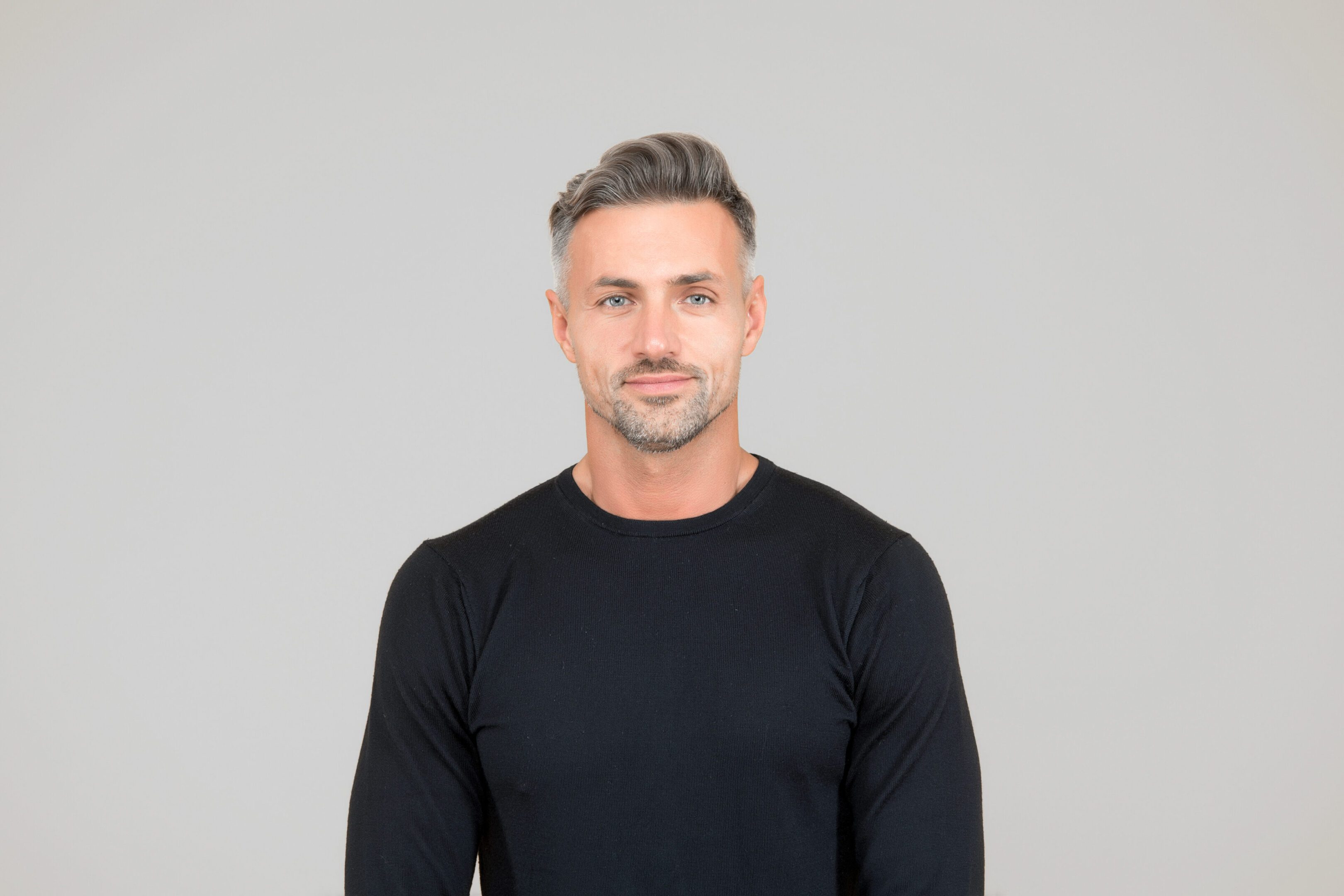 I am just man. Facial care and ageing. Attractive mature man. Mature guy with grey hair and bristle. Men get more attractive with age. Beauty of mature face. Male portrait concept. Perfect skin tone A man with short hair and beard wearing black shirt.