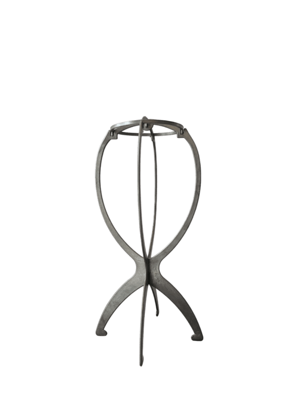 A metal tripod stand with a green background