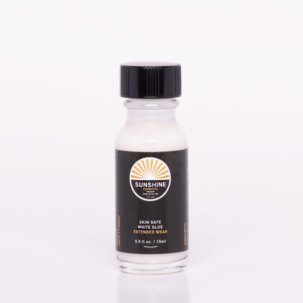 A bottle of hair color on top of a white table.