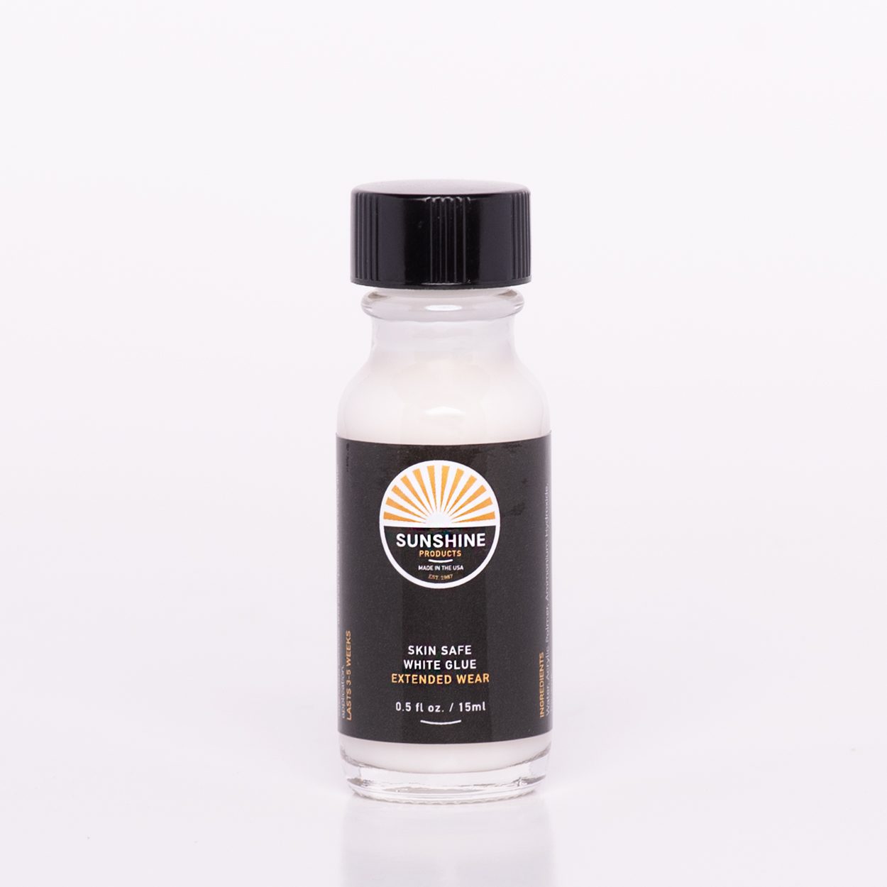 A bottle of hair color on top of a white table.