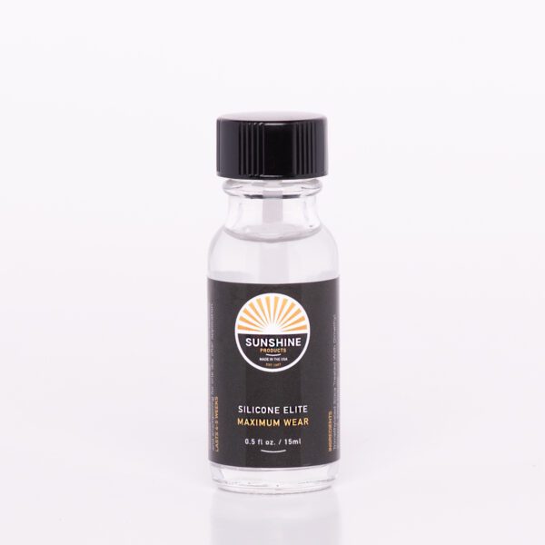 A bottle of fragrance oil sitting on top of a table.