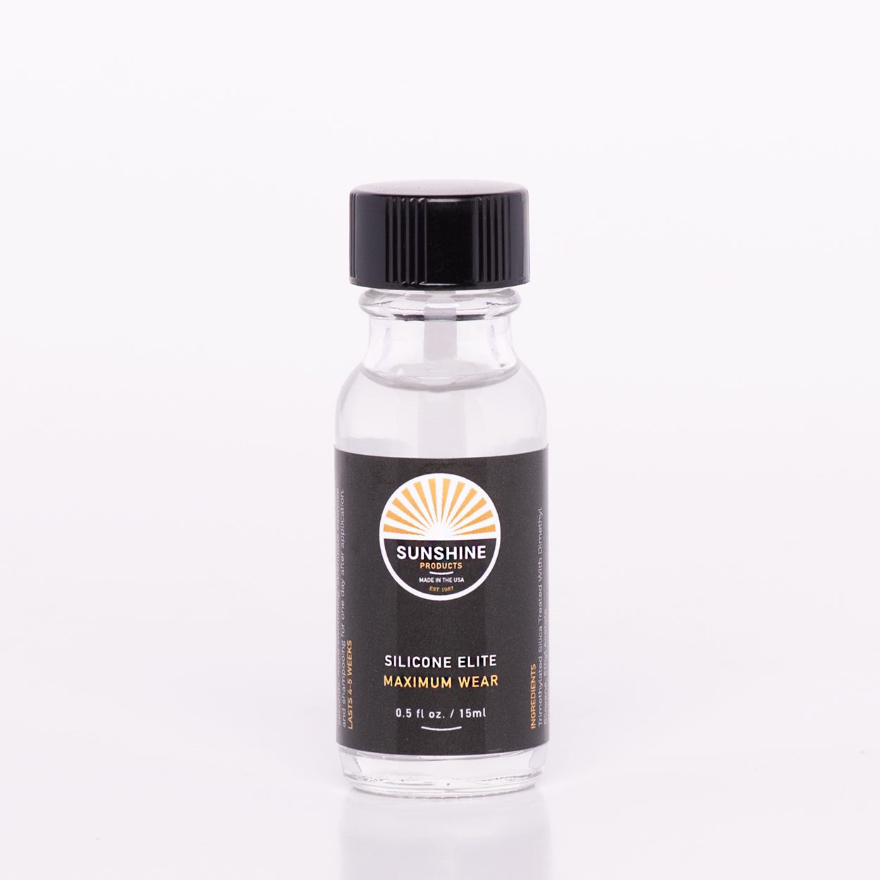 A bottle of fragrance oil sitting on top of a table.