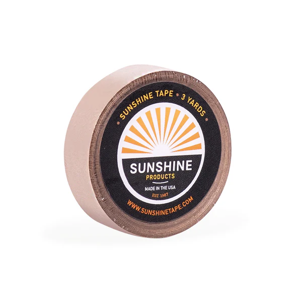 A roll of sunshine tape is sitting on top of a table.