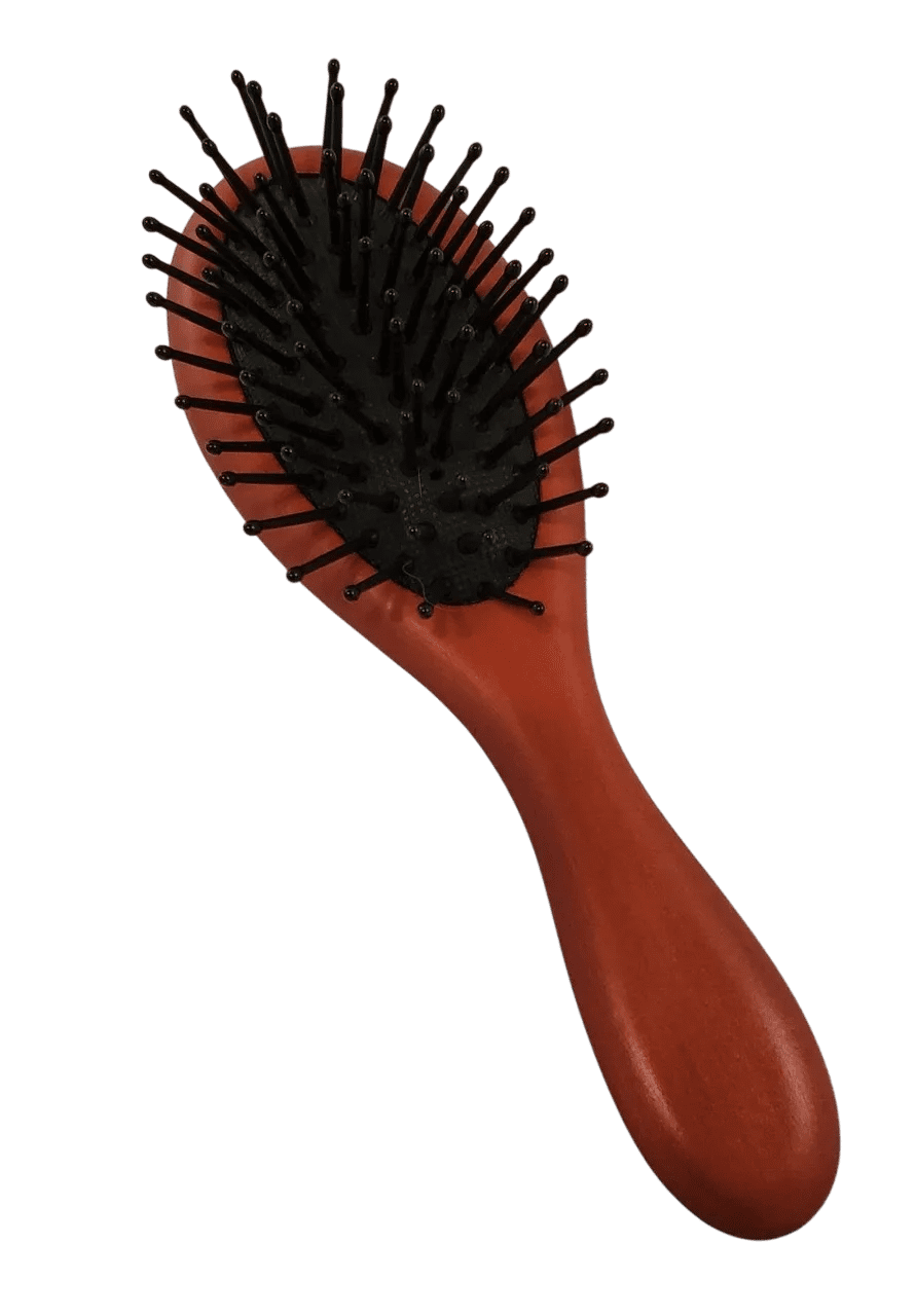 A red hair brush with black bristles on top of it.