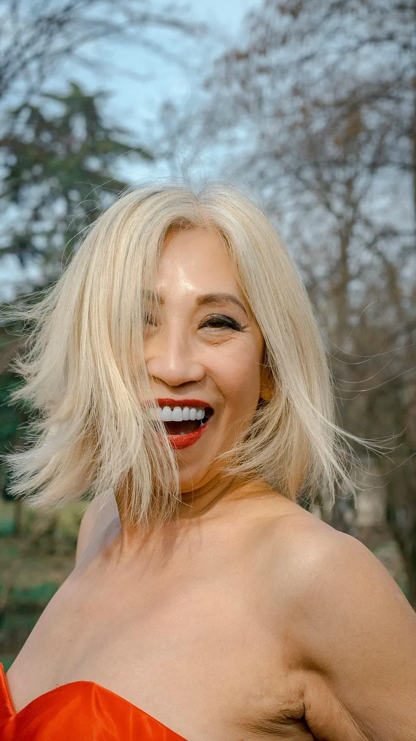 rs=w_1440,h_1440 A woman with blonde hair smiling for the camera.